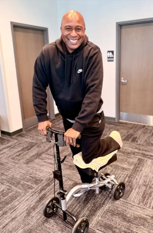 Dr. Jones on a knee scooter during his Achilles recovery